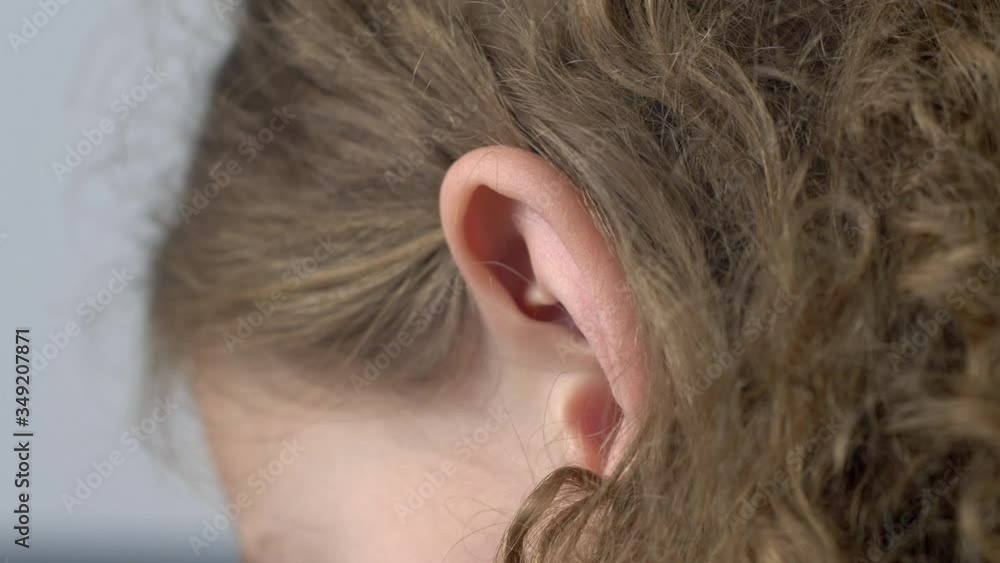 Ear of young girl. Close up view of human ear. Hearing concept Ear of young girl. Close up view of human ear. Hearing concept