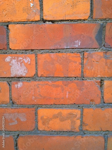Red brick wall background. Old house. Construction industry. Building facade. Copy space. Grunge dirty textured surface. Close up. Brickwork with cement. Need for repair and renovation. Exterior