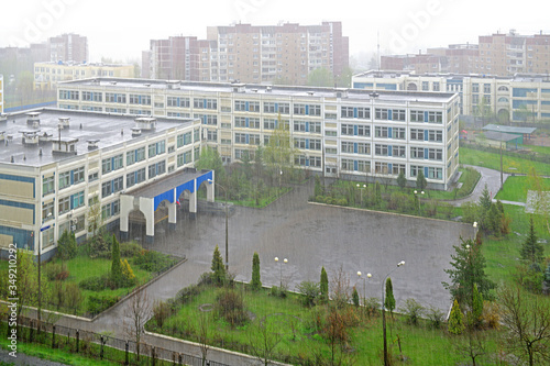 Empty schoolyard during heavy rain in spring. Moscow, Russia