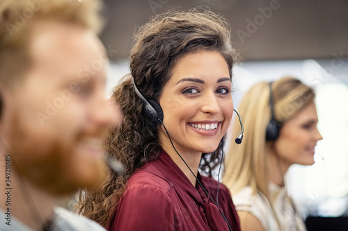 Portrait of smiling woman working in call center photo