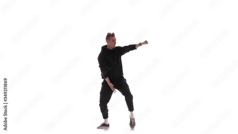 young handsome man in black tracksuit vigorously dancing hip hop, freestyle, street dance, performs complex movements, isolated young handsome man in black tracksuit vigorously dancing hip hop, freestyle, street dance, performs complex movements, isolated