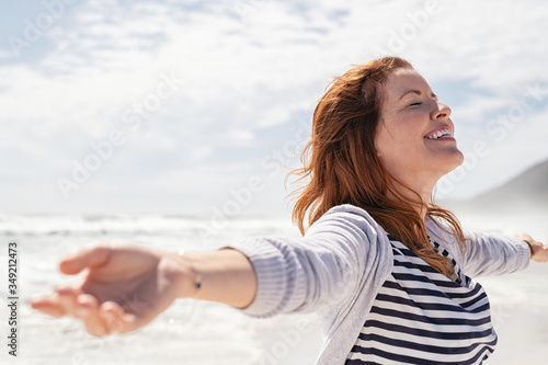 Mature woman enjoy summer beach photo