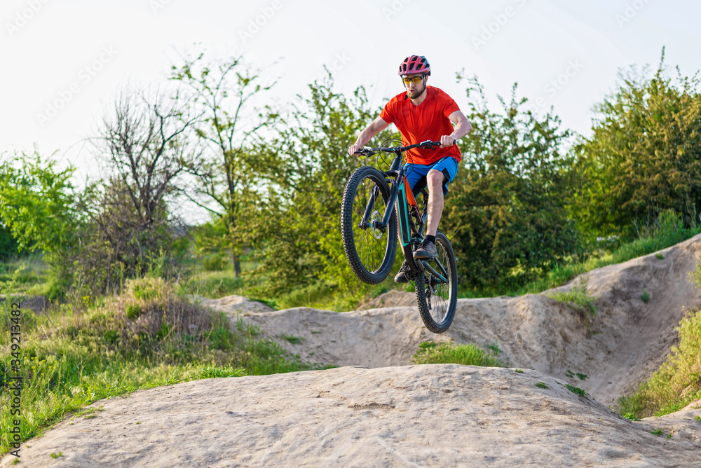 Extreme cycling concept, cyclist jumping on a mountain bike.