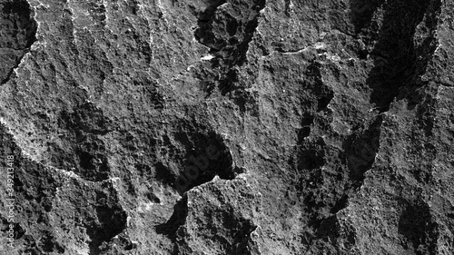 large texture of a large black stone. contrasting light on the stone