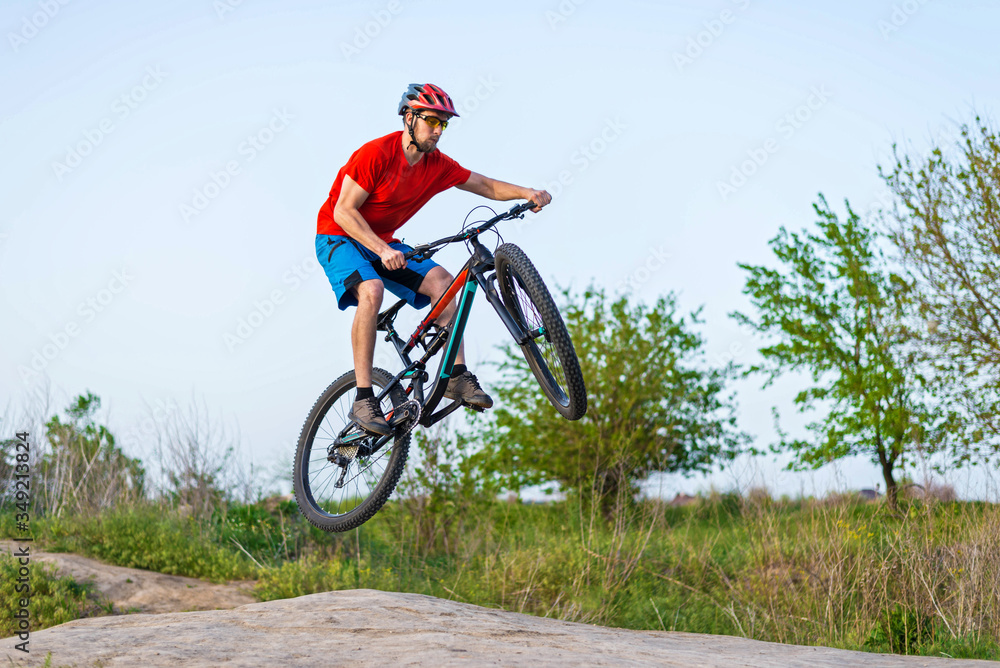 Extreme cycling concept, cyclist jumping on a mountain bike. Extreme cycling concept, cyclist jumping on a mountain bike.