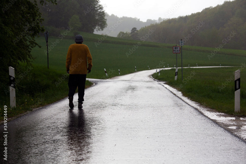 A man goes walking alone to get some exercise during the Corona crisis in Bavaria, Germany.