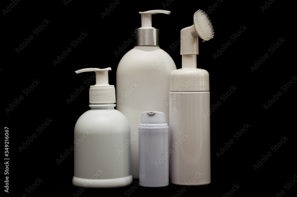 white plastic cosmetic bottle on black background white plastic cosmetic bottle on black background