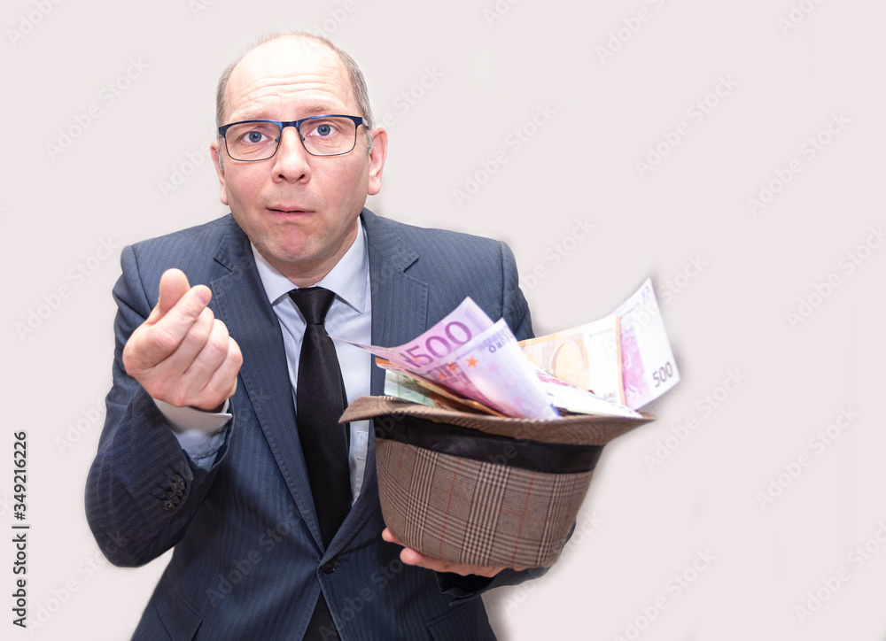 A man in a man’s suit holds a lot of money in his hands. Caucasian, 40 years old shocked. Cash, Euro banknotes. A man in a man’s suit holds a lot of money in his hands. Caucasian, 40 years old shocked. Cash, Euro banknotes.