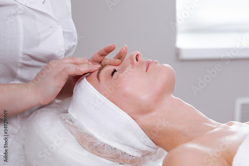 Face massage. Happy woman portrait concept.