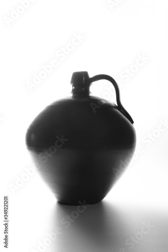 A black clay vase with white background