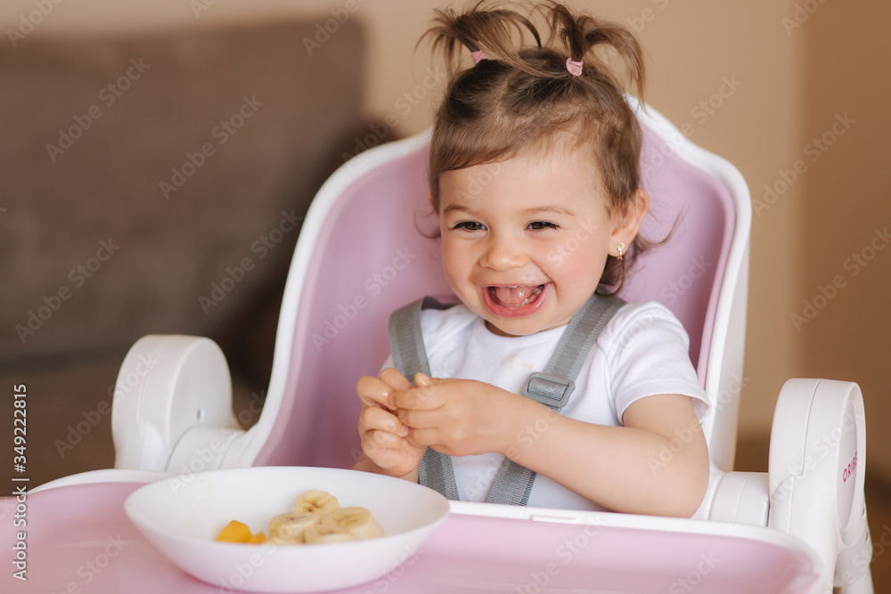 Portrait of cute laughing little girl in hight chair Portrait of cute laughing little girl in hight chair
