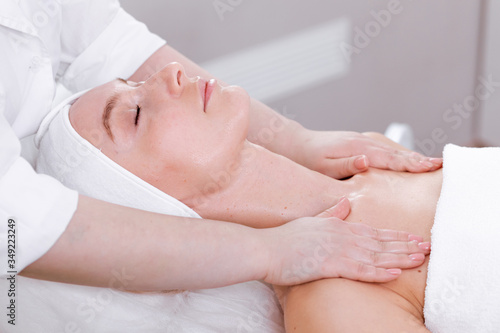 Adult woman in a cosmetology clinic on a rejuvenating facial procedure