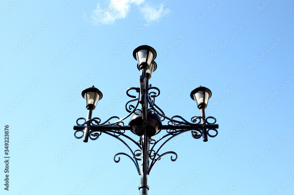 Fragment of a street lamp against the blue sky.