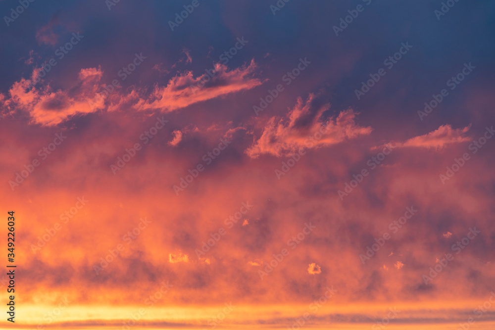 Fototapeta premium Orange sunset with pink-blue clouds