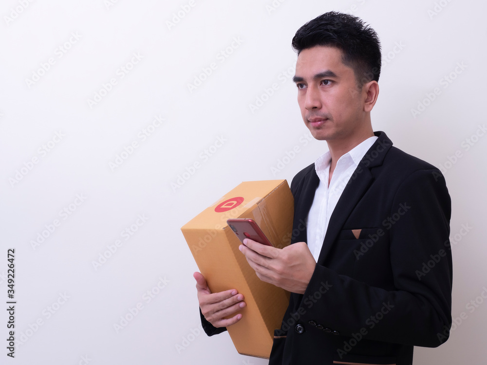 Shipper young Asian man holding cardboard box Shipper young Asian man holding cardboard box