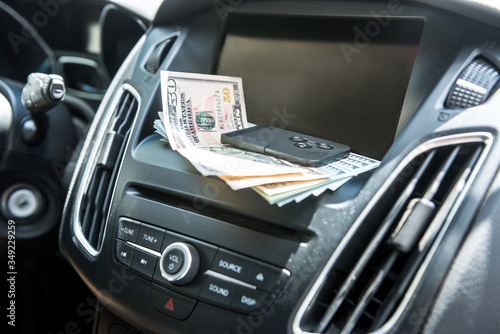 dollars with a car key lie in inside cars