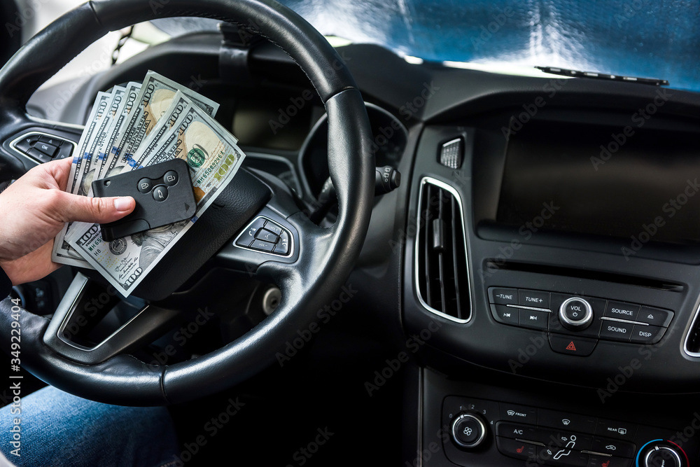 man sitting at auto and count money for pay or buy man sitting at auto and count money for pay or buy