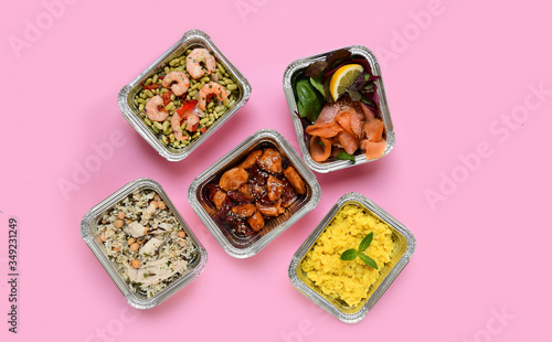 Healthy food restaurant dish delivery. Take away fitness meal banner. Different aluminium lunch box with risotto, chicken chickpeas and rice, salmon salad, hot chicken teriyaki, shrimp and green beans