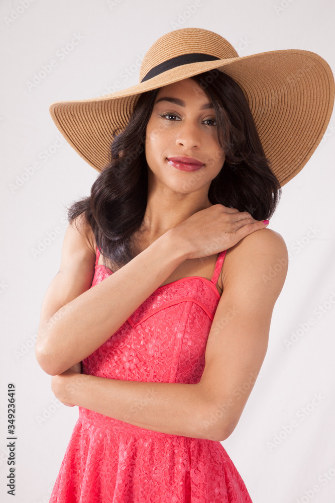 Lovely woman in straw hat and sun dress looking thoughtful Lovely woman in straw hat and sun dress looking thoughtful