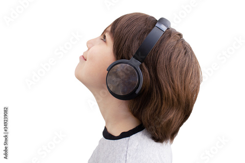 Tablou pe pânză Happy child listening to music looking up with headphones, profile portrait