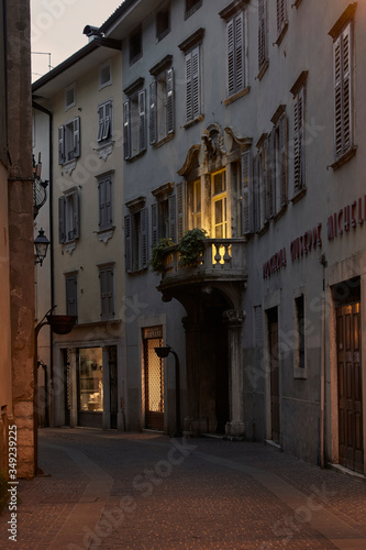 Italian cityscape evening mysterious narrow empty street by night. Night view of the Rovereto city © Antonio