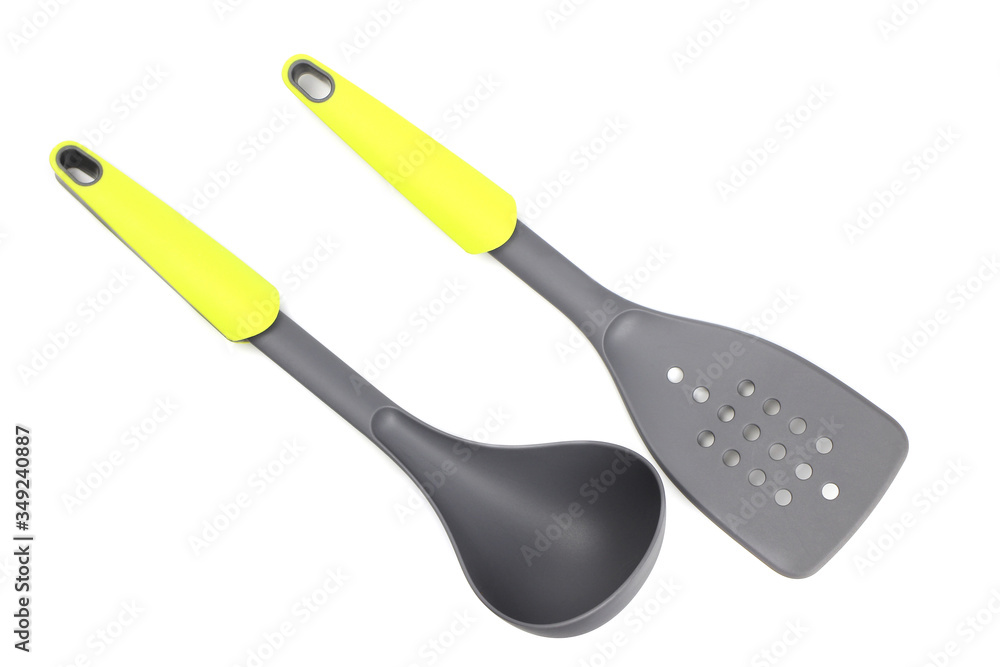 Grey plastic kitchen spatula and ladle with light green inserts isolated on white Grey plastic kitchen spatula and ladle with light green inserts isolated on white