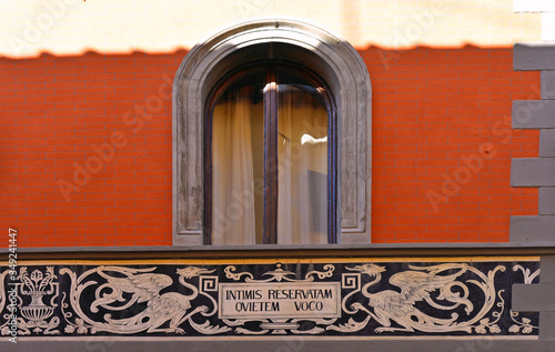 Detail of facade with window and decorations in the medieval village of Sansepolcro near city of Arezzo with house former temple of Freemasonry in Tuscany, Italy photo