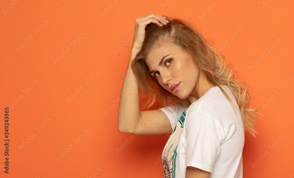 Portrait of a young woman on orange background. Portrait of a young woman on orange background.