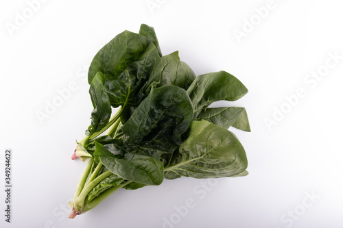 green leaves of spinach isolated on white background