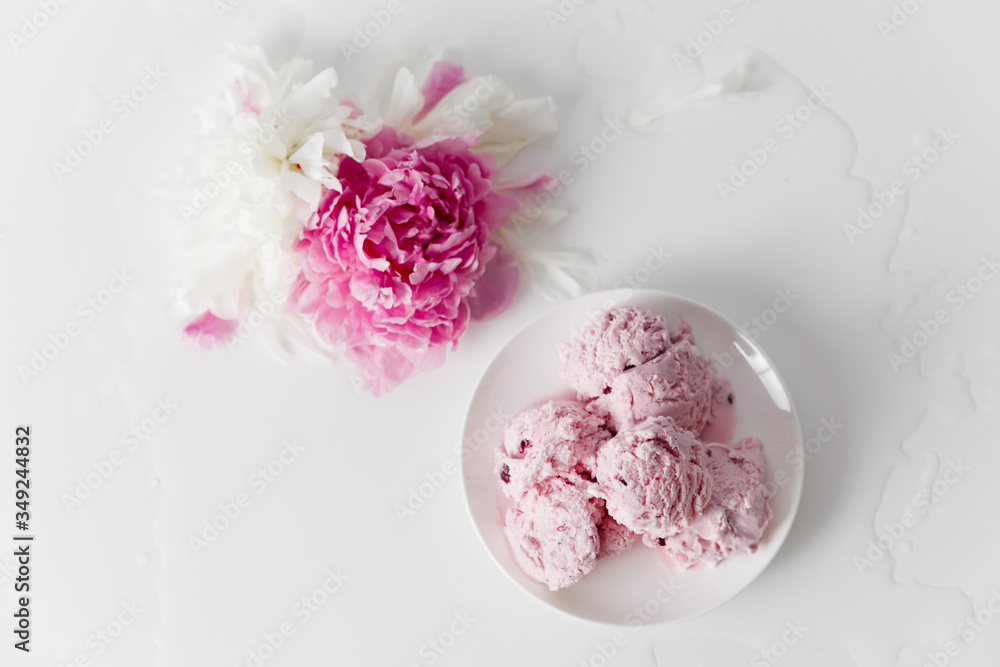Balls of berry ice cream on a plate on a white background Balls of berry ice cream on a plate on a white background