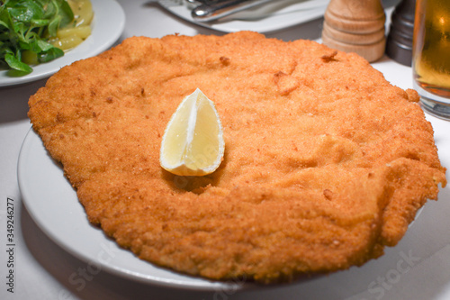 Wiener schnitzel, veal cutlet, austrian cuisine. Served with cold potatoes and rucola salad