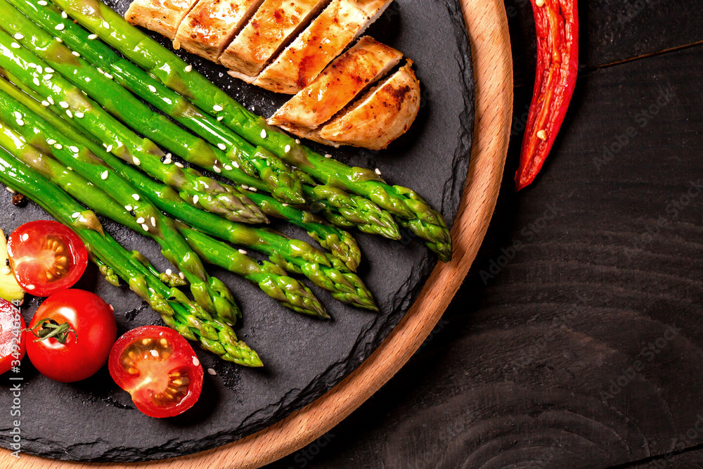 Balanced lunch Healthy grilled chicken, grilled avocado and asparagus salad with seeds. Food recipe background. Close up Balanced lunch Healthy grilled chicken, grilled avocado and asparagus salad with seeds. Food recipe background. Close up