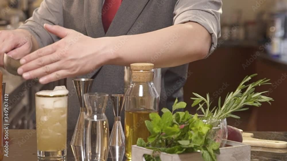 man pouring an ice cube into drink - static front view man pouring an ice cube into drink - static front view