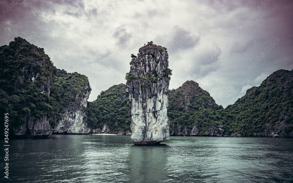 surface rocks in Halong Bay rising above the water at sunset
