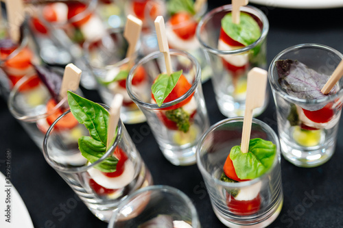 Catering. Canapes with cherry tomatoes and basil leaf