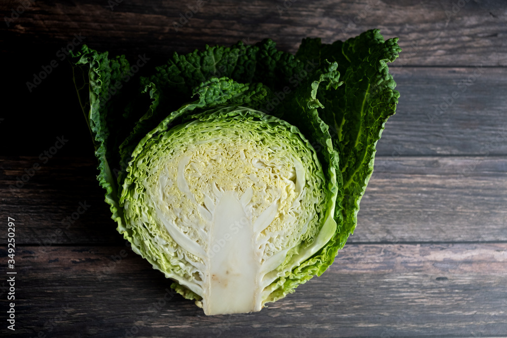 plan view of a half of savoy cabbage plant, on wooden table Stock Photo