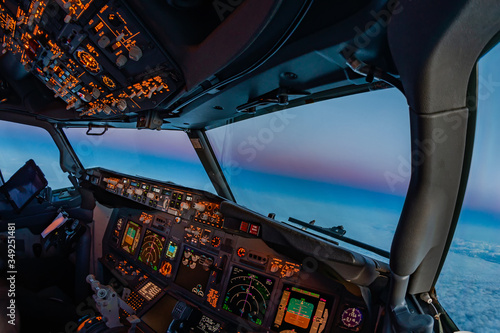 Fotografie Airplane cockpit atmosphere flying towards the oncoming night at dusk