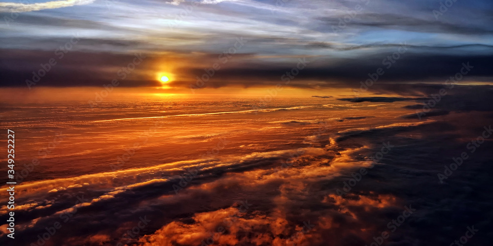 Beautiful sunrise sky full of clouds in dramatic light. Aerial view of a gorgeous morning