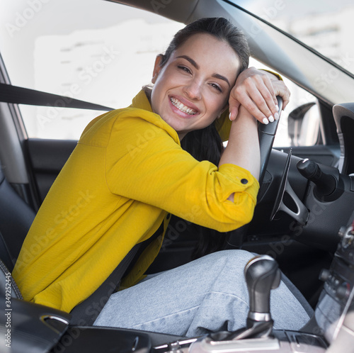Driver smiles and leaning on the steering wheel