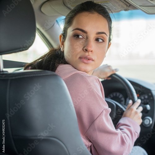 Woman looking at the back of the car