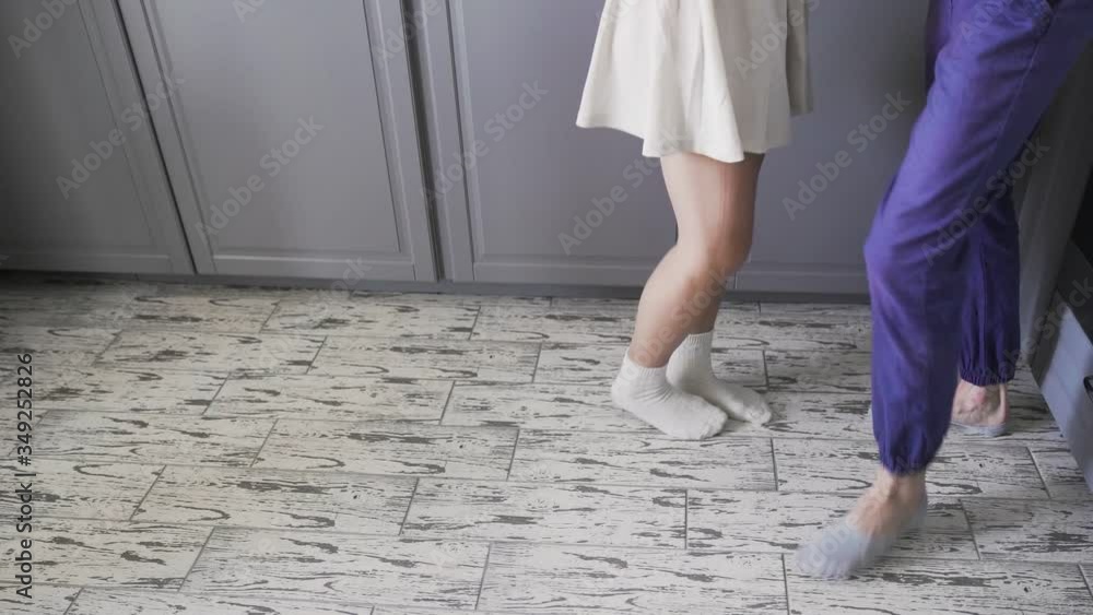 Low angle shot of couple dancing valse in kitchen morning Low angle shot of couple dancing valse in kitchen morning