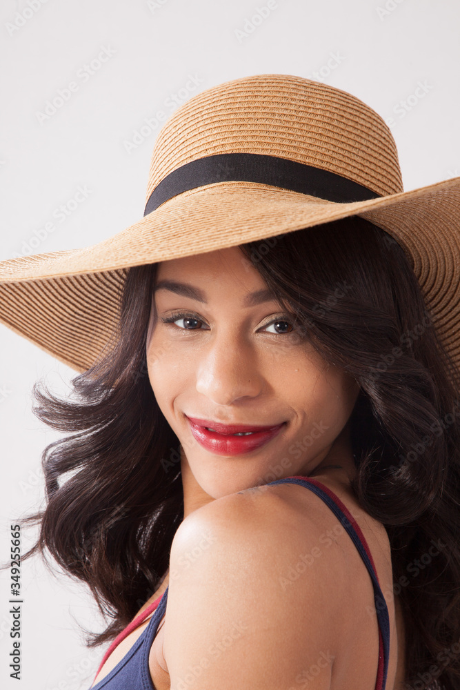 Pretty woman in a straw hat and a smile