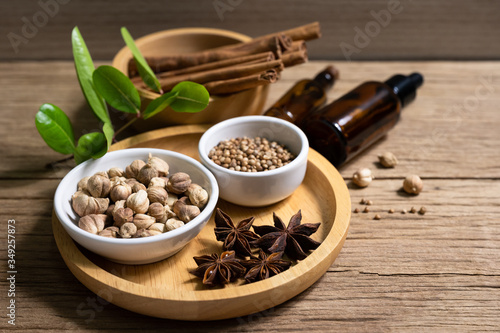 Variety of Thai and Indian spices and natural herbs supplements health food in bowl and spoon on rustic table with copy space.