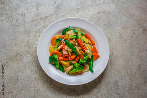 Healthy stir fried vegetables in oyster sauce on white background. Fried vegetables Thai style on white plate.