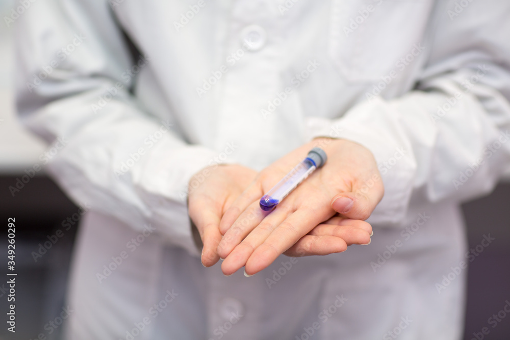 Woman lab technician holding test tube