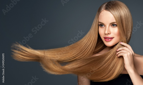 Beautiful model woman with shiny  and straight long hair. Keratin  straightening. Treatment, care and spa procedures. Blonde beauty  girl smooth hairstyle