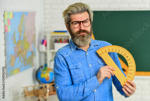 Confident teacher. math teacher at blackboard. education. exact sciences. bearded teacher in glasses. back to school. develop logic and creativity. start the brain engine. physics research