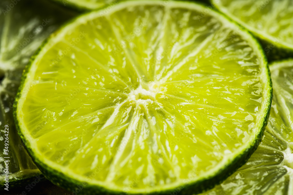 Colorful background with thin lime slices. Selective focus. Shallow depth of field. Colorful background with thin lime slices. Selective focus. Shallow depth of field.
