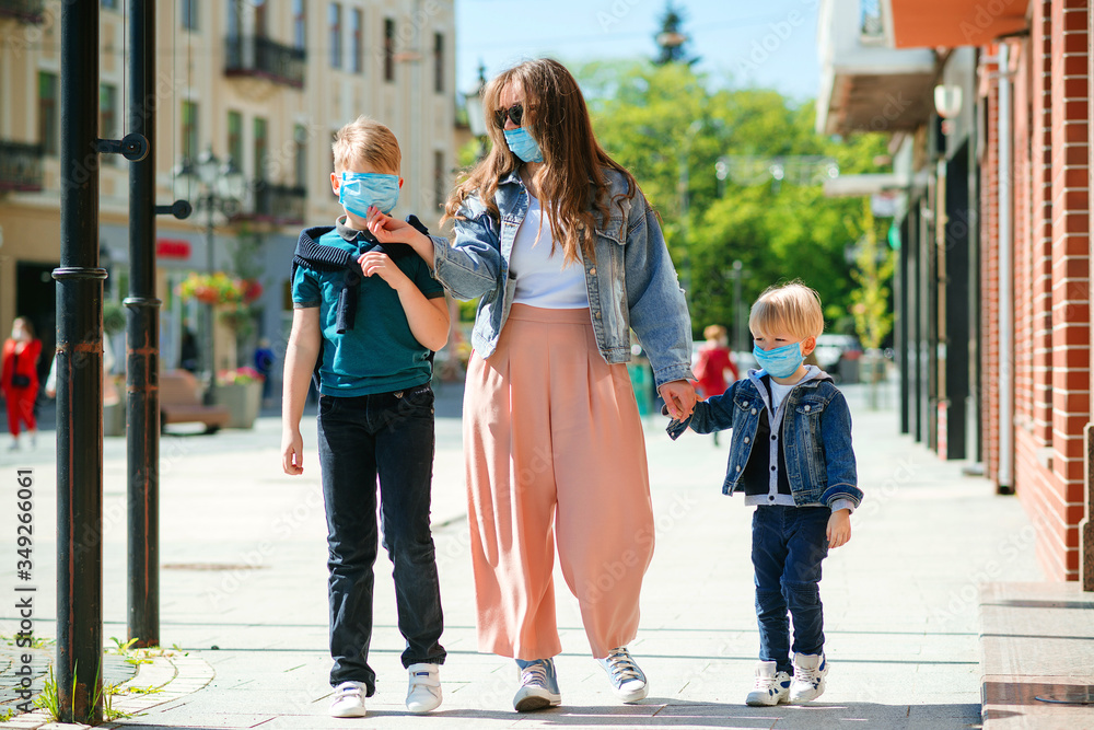 Fototapeta premium Family wearing medical masks. People in safety face mask to protect coronavirus. Children and mom at city street.