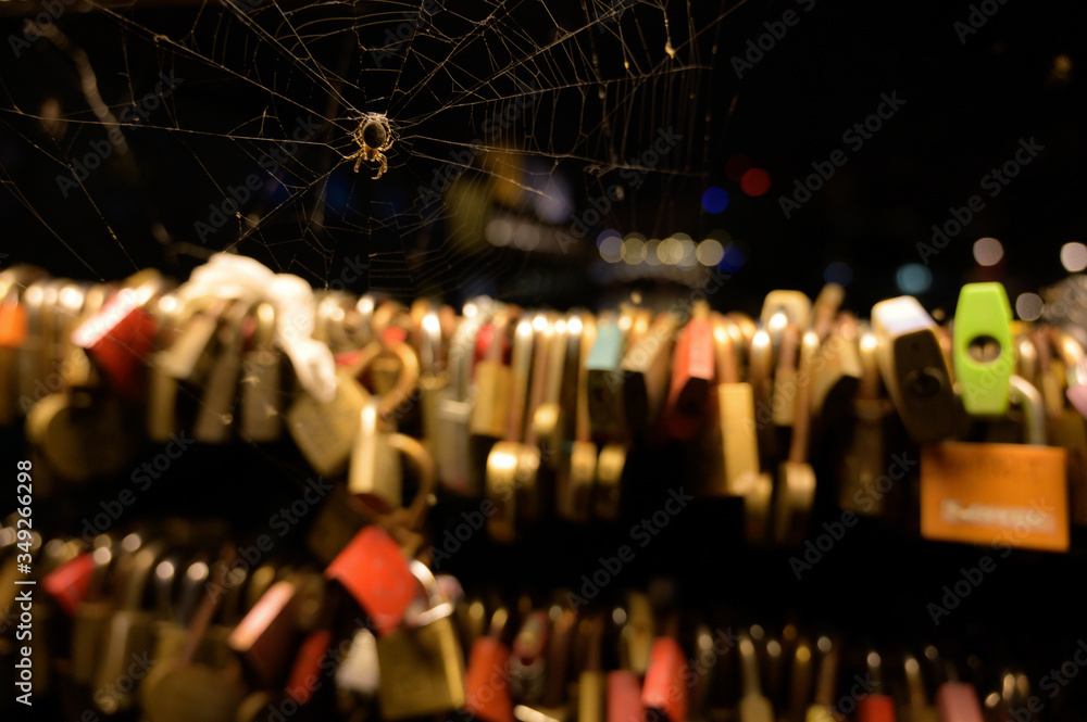 Obraz premium Love locks on Butchers bridge, with spider and web, Ljubljana